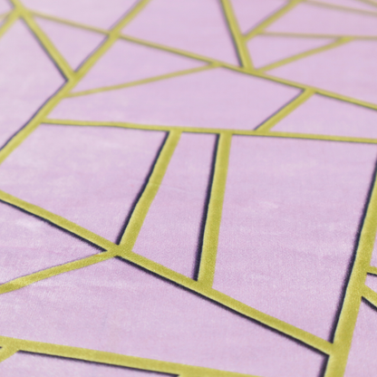 A close-up of a luxurious lavender or lilac fabric featuring a fractured, geometric mosaic pattern. The soft, matte background is segmented by a network of recessed metallic gold lines that form sharp, irregular polygons. This "shattered-glass" effect creates a sophisticated visual contrast, blending the delicate, feminine tones of the textile with shimmering, Art Deco-inspired gold accents for a clean and contemporary look.