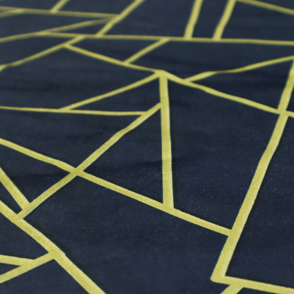 A close-up of a luxurious navy blue fabric featuring a fractured, geometric mosaic pattern. The dark, matte background is segmented by a network of recessed metallic gold lines that form sharp, irregular polygons. This "shattered-glass" or "cracked ice" effect creates a striking visual contrast, blending a deep, oceanic base with shimmering, Art Deco-inspired gold linework for a sophisticated, architectural look.