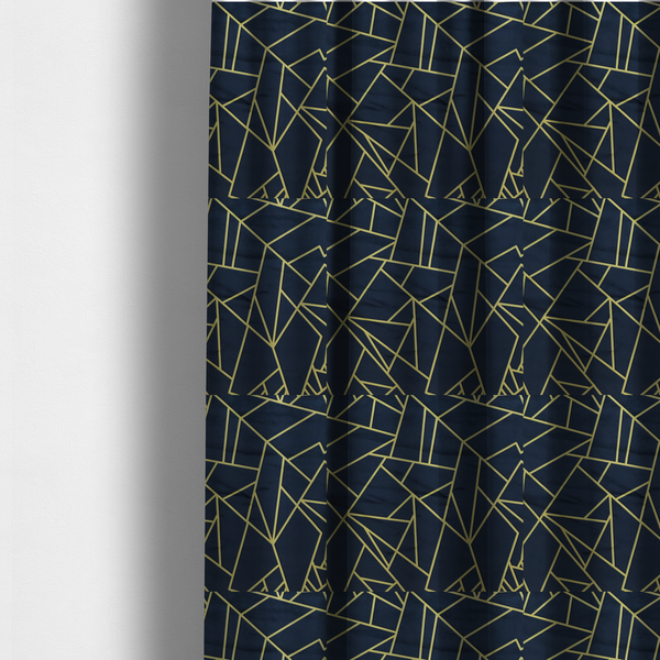 The fabric used to create these made-to-measure curtains is a  luxurious navy blue fabric featuring a fractured, geometric mosaic pattern. The dark, matte background is segmented by a network of recessed metallic gold lines that form sharp, irregular polygons. This "shattered-glass" or "cracked ice" effect creates a striking visual contrast, blending a deep, oceanic base with shimmering, Art Deco-inspired gold linework for a sophisticated, architectural look.