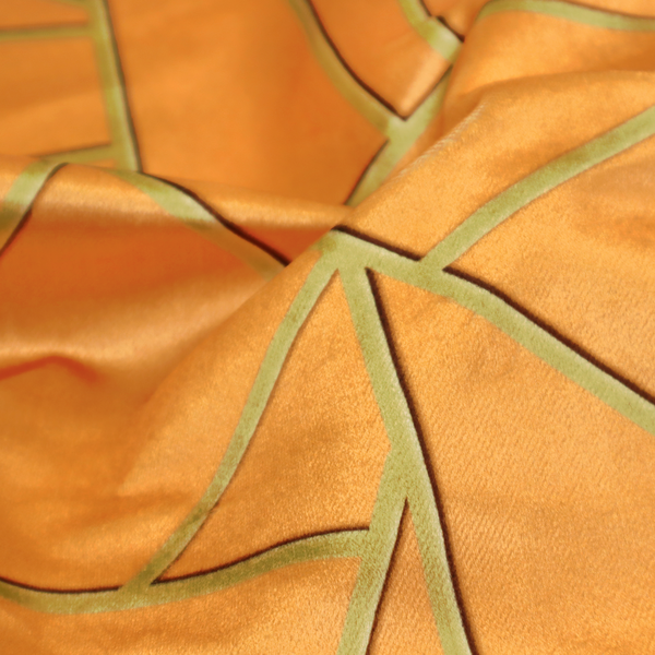 A close-up of a luxurious bright orange or apricot fabric featuring a fractured, geometric mosaic pattern. The warm, vibrant background is segmented by a network of recessed metallic gold lines that form sharp, irregular polygons. This "shattered-glass" effect pairs a bold, citrus-toned base with shimmering, Art Deco-inspired gold linework, creating a high-contrast and architectural look with a subtle 3D texture.