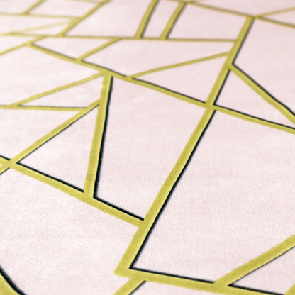 A close-up of a luxurious blush pink or pale rose fabric featuring a fractured, geometric mosaic pattern. The soft, matte background is segmented by a network of recessed metallic gold lines that form sharp, irregular polygons. This "shattered-glass" effect creates a refined visual contrast, blending the subtle, romantic tones of the textile with shimmering, Art Deco-inspired gold accents for a clean and sophisticated look.