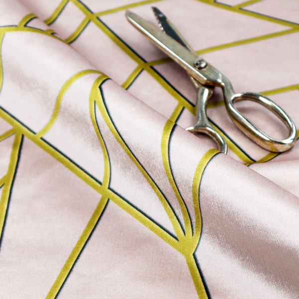 A close-up of a luxurious blush pink or pale rose fabric featuring a fractured, geometric mosaic pattern. The soft, matte background is segmented by a network of recessed metallic gold lines that form sharp, irregular polygons. This "shattered-glass" effect creates a refined visual contrast, blending the subtle, romantic tones of the textile with shimmering, Art Deco-inspired gold accents for a clean and sophisticated look.