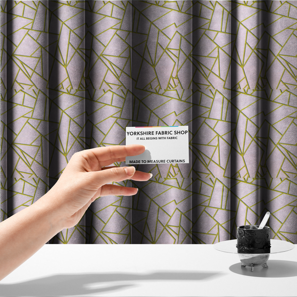 The fabric used to create these made-to-measure curtains is a luxurious blush pink or pale rose fabric featuring a fractured, geometric mosaic pattern. The soft, matte background is segmented by a network of recessed metallic gold lines that form sharp, irregular polygons. This "shattered-glass" effect creates a refined visual contrast, blending the subtle, romantic tones of the textile with shimmering, Art Deco-inspired gold accents for a clean and sophisticated look.