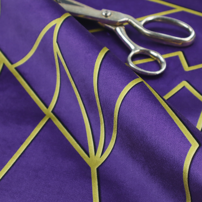 A close-up of a luxurious deep purple or violet fabric featuring a fractured, geometric mosaic pattern. The dark, matte background is segmented by a network of recessed metallic gold lines that form sharp, irregular polygons. This "shattered-glass" effect creates a dramatic visual contrast, blending the rich, royal tones of the textile with shimmering, Art Deco-inspired gold accents for a bold and sophisticated look.