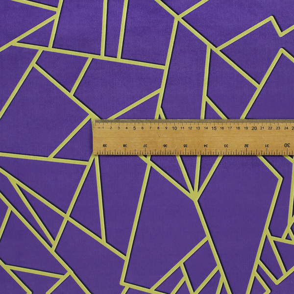 A close-up of a luxurious deep purple or violet fabric featuring a fractured, geometric mosaic pattern. The dark, matte background is segmented by a network of recessed metallic gold lines that form sharp, irregular polygons. This "shattered-glass" effect creates a dramatic visual contrast, blending the rich, royal tones of the textile with shimmering, Art Deco-inspired gold accents for a bold and sophisticated look.