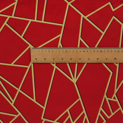 A close-up of a luxurious vibrant red fabric featuring a fractured, geometric mosaic pattern. The rich, matte background is segmented by a network of recessed metallic gold lines that form sharp, irregular polygons. This "shattered-glass" or "cracked ice" effect creates a striking visual contrast, blending the intense red base with shimmering, Art Deco-inspired gold linework for a dramatic and architectural look.
