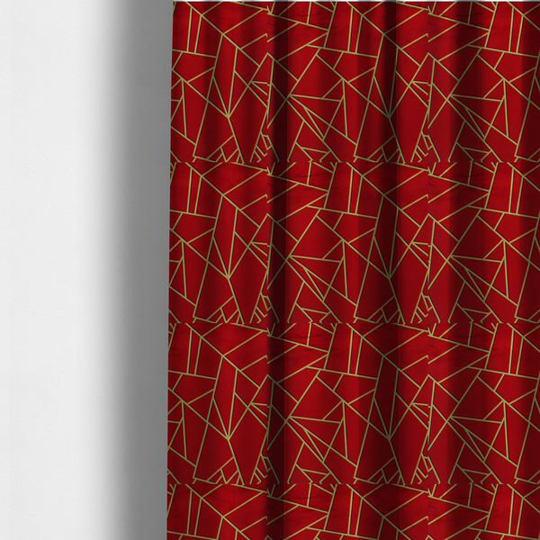 The fabric used to create these made-to-measure curtains is a luxurious vibrant red fabric featuring a fractured, geometric mosaic pattern. The rich, matte background is segmented by a network of recessed metallic gold lines that form sharp, irregular polygons. This "shattered-glass" or "cracked ice" effect creates a striking visual contrast, blending the intense red base with shimmering, Art Deco-inspired gold linework for a dramatic and architectural look.