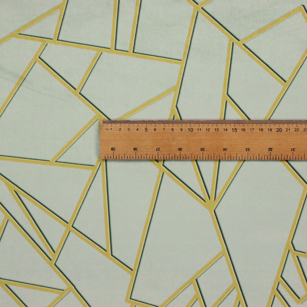 A close-up of a luxurious silver fabric featuring a fractured, geometric mosaic pattern. The soft, matte background is segmented by a network of recessed metallic gold lines that form sharp, irregular polygons. This "shattered-glass" effect creates a calm yet architectural look, blending cool, desaturated tones with shimmering, Art Deco-inspired gold linework for a high-end, contemporary finish.