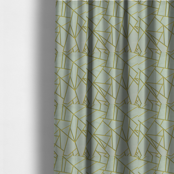 The fabric used to create these made-to-measure curtains is a luxurious silver fabric featuring a fractured, geometric mosaic pattern. The soft, matte background is segmented by a network of recessed metallic gold lines that form sharp, irregular polygons. This "shattered-glass" effect creates a calm yet architectural look, blending cool, desaturated tones with shimmering, Art Deco-inspired gold linework for a high-end, contemporary finish.