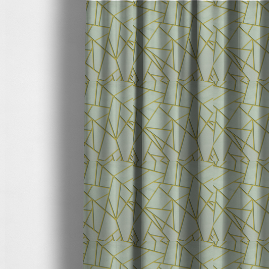 The fabric used to create these made-to-measure curtains is a luxurious silver fabric featuring a fractured, geometric mosaic pattern. The soft, matte background is segmented by a network of recessed metallic gold lines that form sharp, irregular polygons. This "shattered-glass" effect creates a calm yet architectural look, blending cool, desaturated tones with shimmering, Art Deco-inspired gold linework for a high-end, contemporary finish.