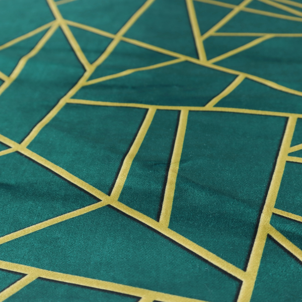 A close-up of a luxurious deep peacock or dark teal fabric featuring a fractured, geometric mosaic pattern. The moody, matte background is segmented by a network of recessed metallic gold lines that form sharp, irregular polygons. This "shattered-glass" effect pairs a sophisticated, dark jewel-toned base with shimmering, Art Deco-inspired gold accents for a dramatic and architectural look.