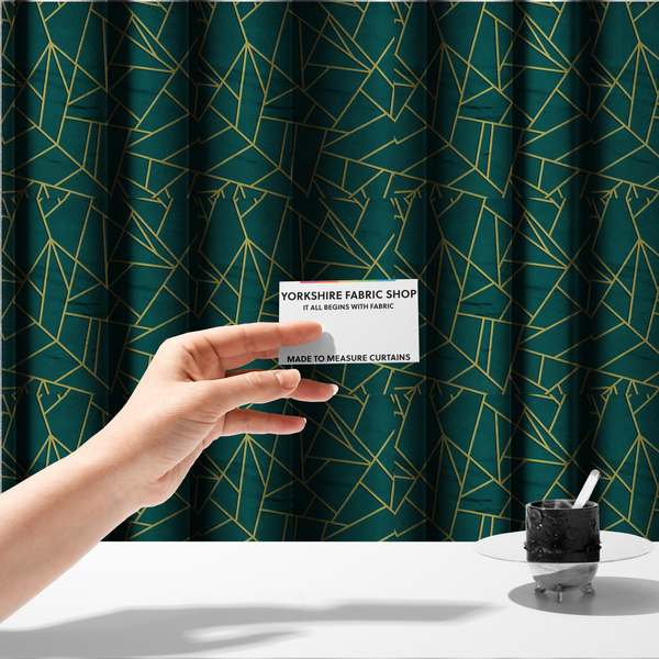 The fabric used to create these made-to-measure curtains is a luxurious deep peacock or dark teal fabric featuring a fractured, geometric mosaic pattern. The moody, matte background is segmented by a network of recessed metallic gold lines that form sharp, irregular polygons. This "shattered-glass" effect pairs a sophisticated, dark jewel-toned base with shimmering, Art Deco-inspired gold accents for a dramatic and architectural look.