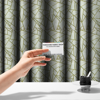 The fabric used to create these made-to-measure curtains is a luxurious stark white or ivory fabric featuring a fractured, geometric mosaic pattern. The clean, matte background is segmented by a network of recessed metallic gold lines that form sharp, irregular polygons. This "shattered-glass" effect creates a sophisticated architectural look, pairing a bright, neutral base with shimmering, Art Deco-inspired gold linework for a high-contrast and contemporary finish