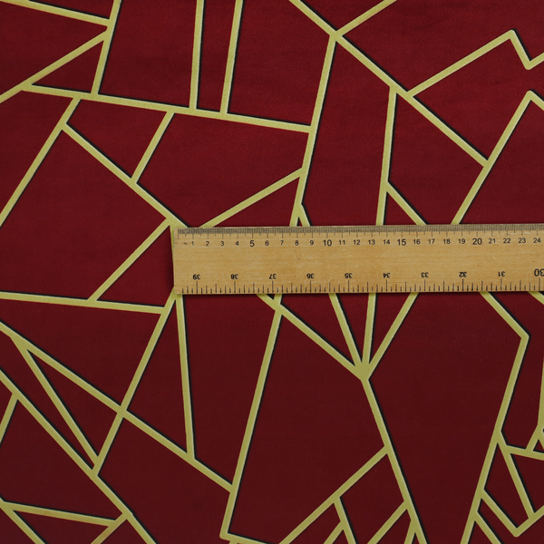 A close-up of a luxurious burgundy or wine red fabric featuring a fractured, geometric mosaic pattern. The dark, velvety matte background is segmented by a network of recessed metallic gold lines that form sharp, irregular polygons. This "shattered-glass" effect pairs a rich, deep-toned base with shimmering, Art Deco-inspired gold linework for a dramatic and architectural look.