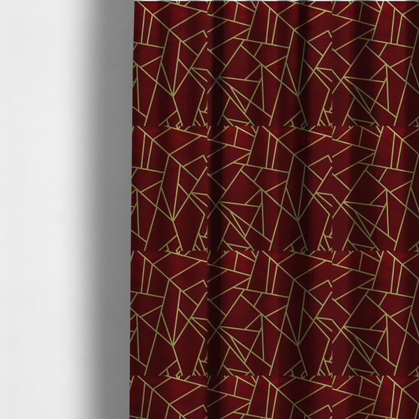 The fabric used to create these made-to-measure curtains is a  luxurious burgundy or wine red fabric featuring a fractured, geometric mosaic pattern. The dark, velvety matte background is segmented by a network of recessed metallic gold lines that form sharp, irregular polygons. This "shattered-glass" effect pairs a rich, deep-toned base with shimmering, Art Deco-inspired gold linework for a dramatic and architectural look.