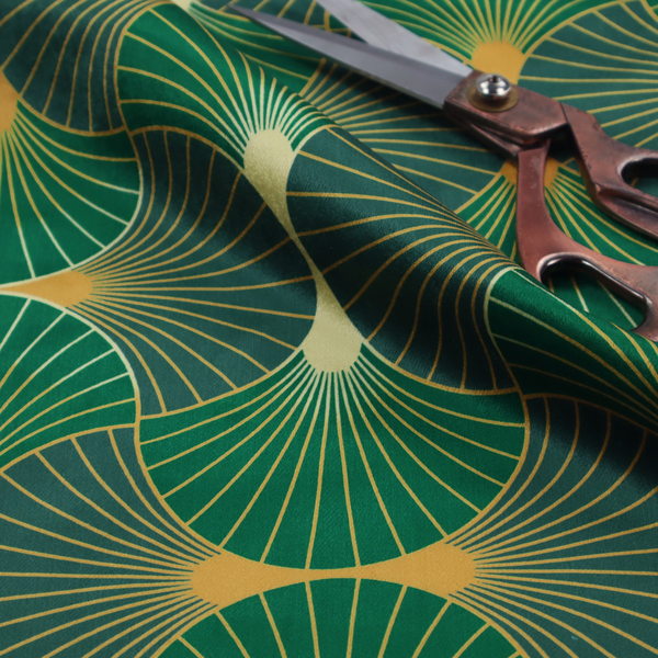 This fabric features a sophisticated Art Deco fan pattern in a moodier, more saturated colour palette than the previous version. The interlocking scallop design creates a dense, elegant texture suitable for high-end decor.