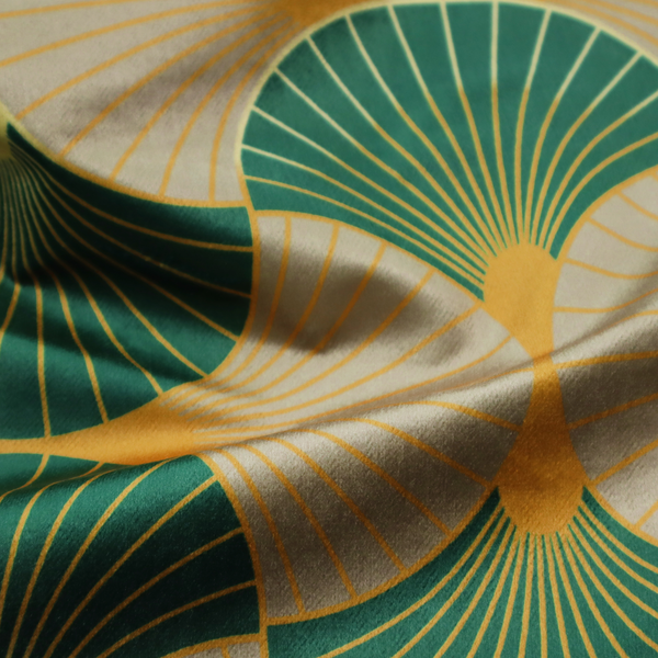 The DP-384-1 fabric showcases a sophisticated Art Deco aesthetic through a rhythmic, interlocking scalloped fan motif. This geometric pattern features a balanced, three-tone colour scheme: deep forest green provides bold structure, a warm taupe or sand neutral adds earthy softness, and muted gold accents highlight the radiating lines and central focal points. 