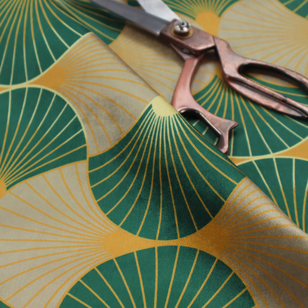 The DP-384-1 fabric showcases a sophisticated Art Deco aesthetic through a rhythmic, interlocking scalloped fan motif. This geometric pattern features a balanced, three-tone colour scheme: deep forest green provides bold structure, a warm taupe or sand neutral adds earthy softness, and muted gold accents highlight the radiating lines and central focal points. 