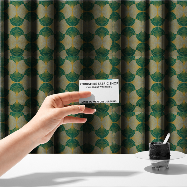 The fabric used to create these made-to-measure curtains, presents a sophisticated Art Deco aesthetic featuring an interlocking scalloped fan motif that creates a rhythmic, architectural symmetry across the textile. This specific variation utilizes a refined colour palette of deep emerald green, cool slate grey, and warm ochre. The pattern is composed of alternating shells where thin lines radiate from golden central points, set against a subtle cream background that peeks through at the base of each fan.