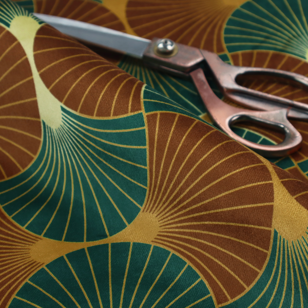 The DP-391-1 fabric offers a grounded and earthy interpretation of the classic Art Deco fan motif. This design features a rhythmic, interlocking scalloped shell pattern where fine lines radiate from central golden-ochre focal points to create a symmetrical "fish scale" layout. This specific version is defined by its sophisticated colour story, pairing deep forest green with rich terracotta or rust brown.