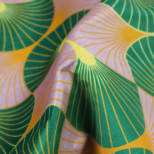 The DP-395-1 fabric features an elegant and playful Art Deco aesthetic, characterized by its interlocking scalloped fan motif and a unique, soft colour palette.