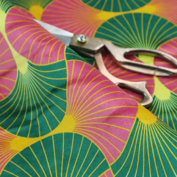The DP-398-1 fabric features a bold and high-energy Art Deco aesthetic, characterized by its signature interlocking scalloped fan motif in a vibrant, modern colourway.
