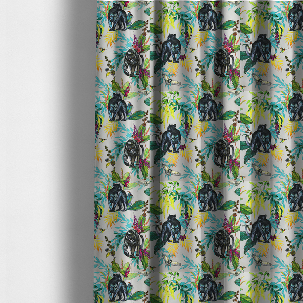 The fabric used to create these made-to-measure curtains is a vibrant tropical fabric print featuring sleek black panthers prowling among exotic flora. The design includes colourful botanical elements like oversized teal and lime green leaves, magenta flowers, and yellow ferns. Small details like a soaring owl and a hummingbird are scattered throughout on a pale grey background.