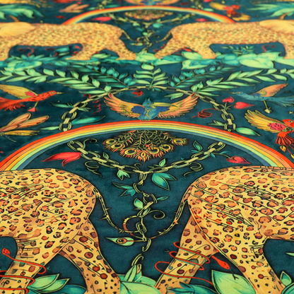 A fabric with large elephants patterned with leopard-like spots facing one another.