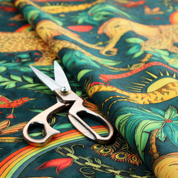 A fabric with large elephants patterned with leopard-like spots facing one another.