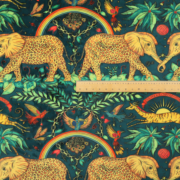 A fabric with large elephants patterned with leopard-like spots facing one another.