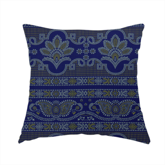 The fabric used to create this handmade cushion is an intricate royal blue and yellow fabric featuring traditional ornate damask and paisley motifs arranged in horizontal decorative bands.