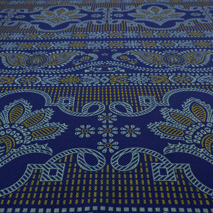 Intricate royal blue and yellow fabric featuring traditional ornate damask and paisley motifs arranged in horizontal decorative bands.