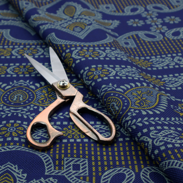 Intricate royal blue and yellow fabric featuring traditional ornate damask and paisley motifs arranged in horizontal decorative bands.