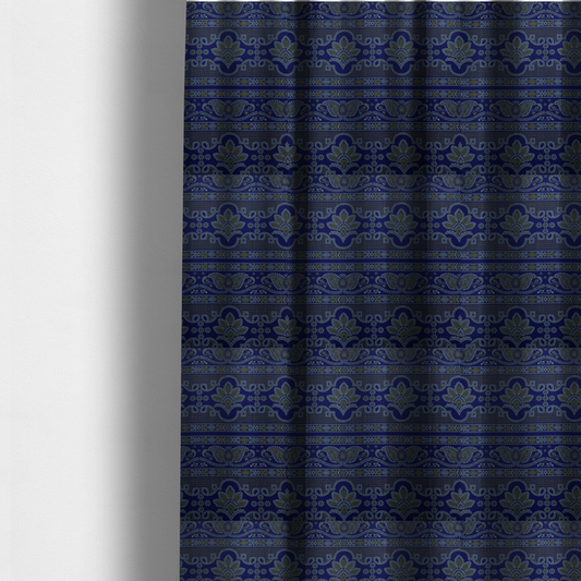The fabric used to create these made-to-measure curtains has an intricate royal blue and yellow fabric featuring traditional ornate damask and paisley motifs arranged in horizontal decorative bands.