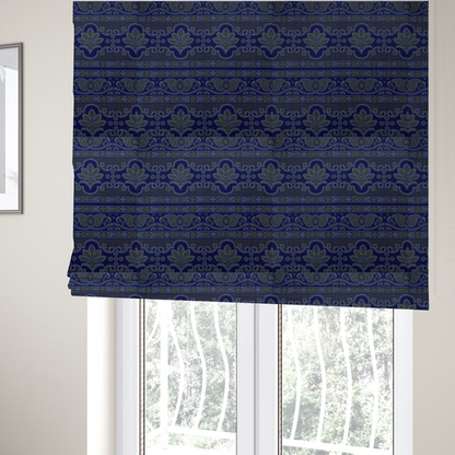 The fabric used to create these Roman blinds is an intricate royal blue and yellow fabric featuring traditional ornate damask and paisley motifs arranged in horizontal decorative bands.