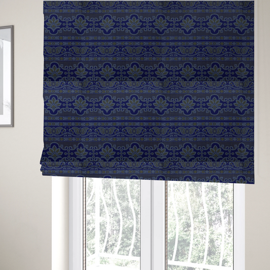 The fabric used to create these Roman blinds is an intricate royal blue and yellow fabric featuring traditional ornate damask and paisley motifs arranged in horizontal decorative bands.