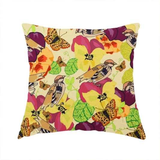 The fabric used to create this handmade cushion is a detailed repeating pattern featuring sparrows, butterflies, and large pansy flowers in shades of yellow, purple, orange, and red against a cream background.