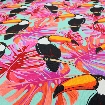 This fabric features vibrant, tropical-themed repeating pattern showcasing toucans and exotic foliage.