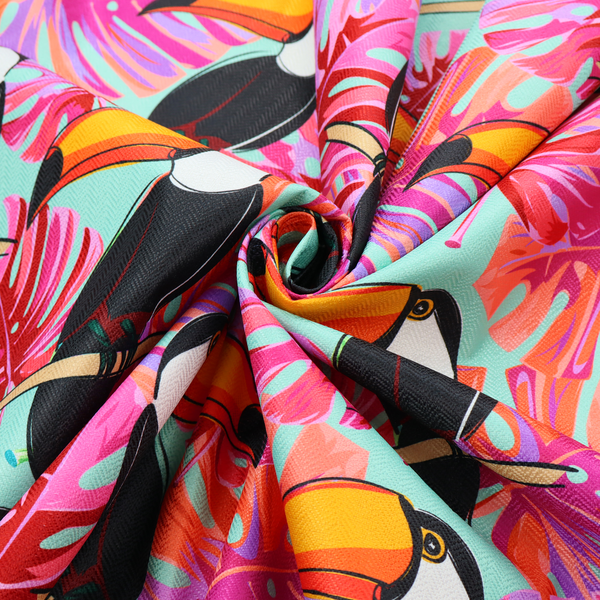 This fabric features vibrant, tropical-themed repeating pattern showcasing toucans and exotic foliage.