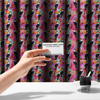 The fabric used to create these made-to-measure curtains features vibrant, tropical-themed repeating pattern showcasing toucans and exotic foliage.