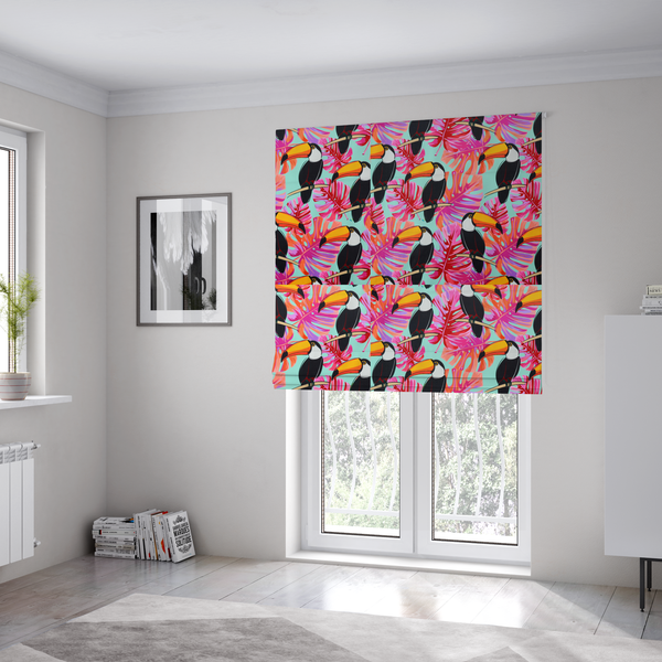 The fabric used to create these Roman blinds features vibrant, tropical-themed repeating pattern showcasing toucans and exotic foliage.