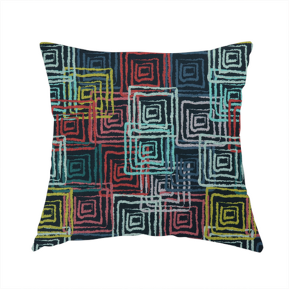 The fabric used to create this handmade cushion is an abstract geometric pattern featuring overlapping nested squares in vibrant shades of red, teal, yellow, and grey on a dark background.