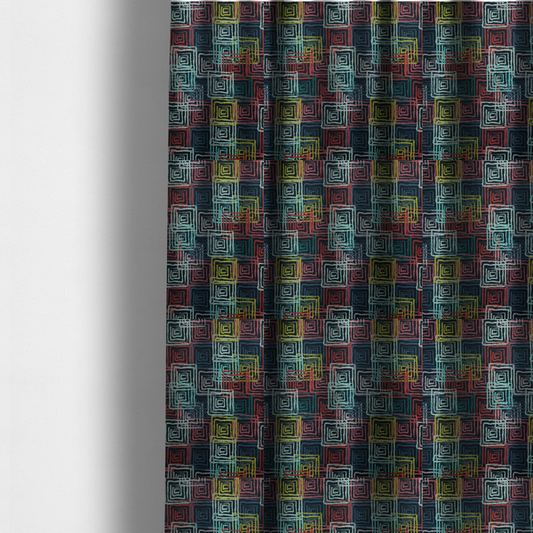 The fabric used to create these made-to-measure curtains is an abstract geometric pattern featuring overlapping nested squares in vibrant shades of red, teal, yellow, and grey on a dark background.
