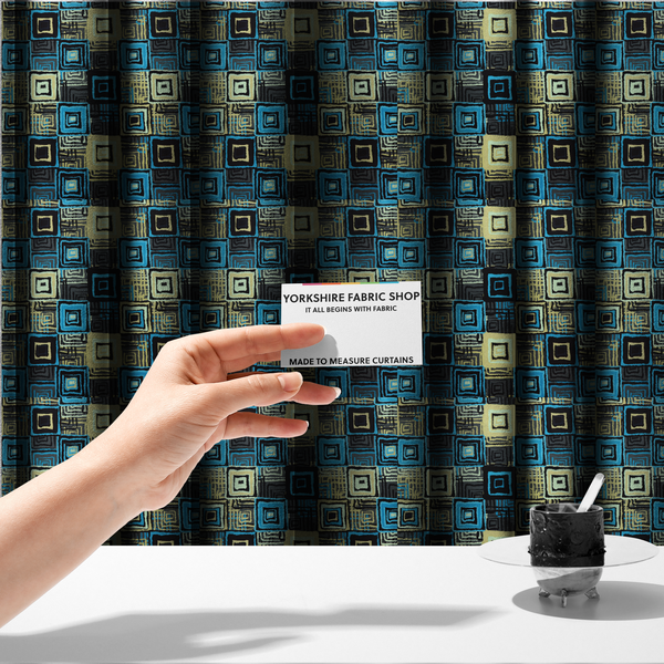 The fabric used to create these made-to-measure curtains is an abstract geometric pattern featuring nested squares in shades of bright blue, pale yellow, dark grey, and black.