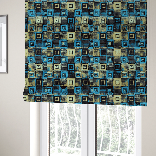 The fabric used to create these Roman blinds is an abstract geometric pattern featuring nested squares in shades of bright blue, pale yellow, dark grey, and black.