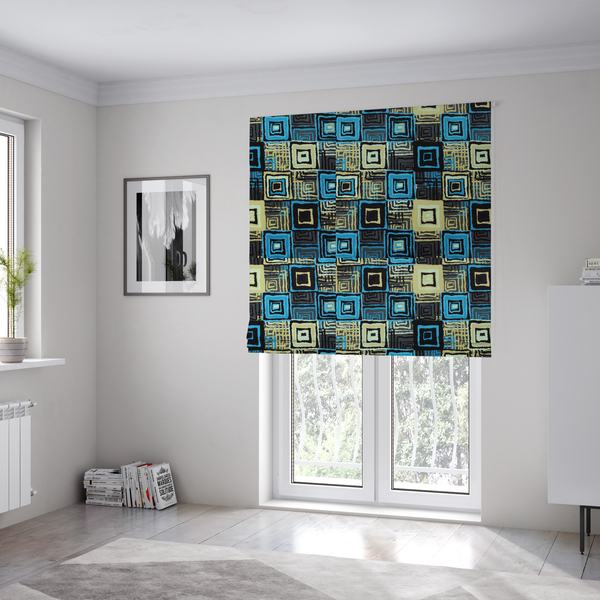 The fabric used to create these Roman blinds is an abstract geometric pattern featuring nested squares in shades of bright blue, pale yellow, dark grey, and black.