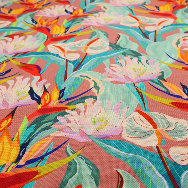 Vibrant repeating botanical pattern featuring tropical flowers, including birds of paradise and white anthuriums, with large green leaves against a dusty pink background.