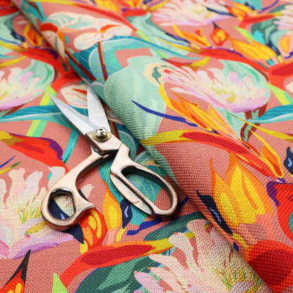 Vibrant repeating botanical pattern featuring tropical flowers, including birds of paradise and white anthuriums, with large green leaves against a dusty pink background.