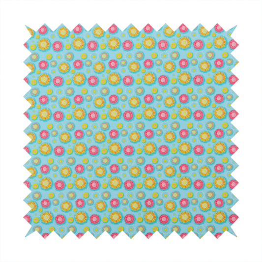 Light blue fabric featuring an all-over repeating pattern of vibrant pink and gold floral motifs interspersed with small yellow dotted accents.