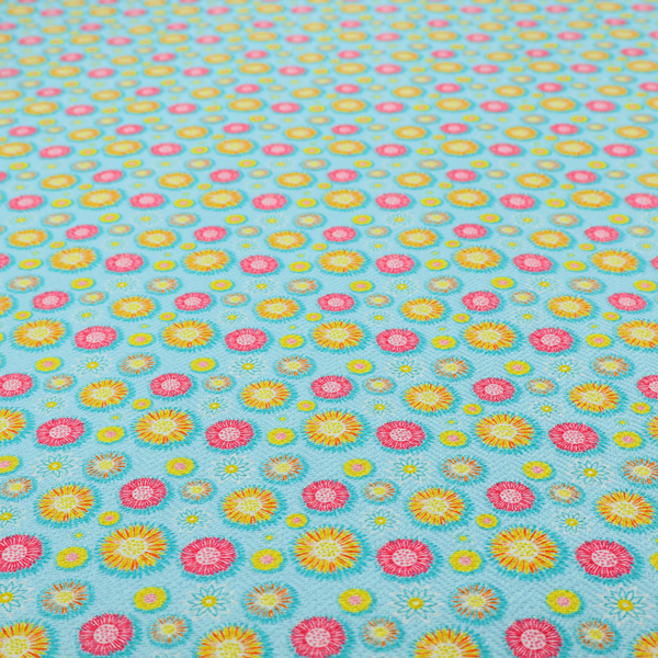 Light blue fabric featuring an all-over repeating pattern of vibrant pink and gold floral motifs interspersed with small yellow dotted accents.